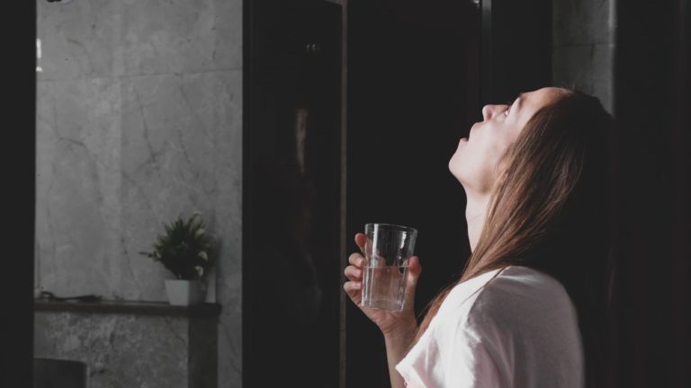 young woman rinses her mouth with water while look 2021 08 29 01 24 05 utc