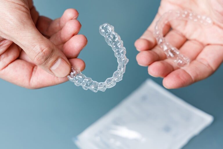 hands holding transparent aligners invisalign ort 2023 02 28 18 33 53 utc 1