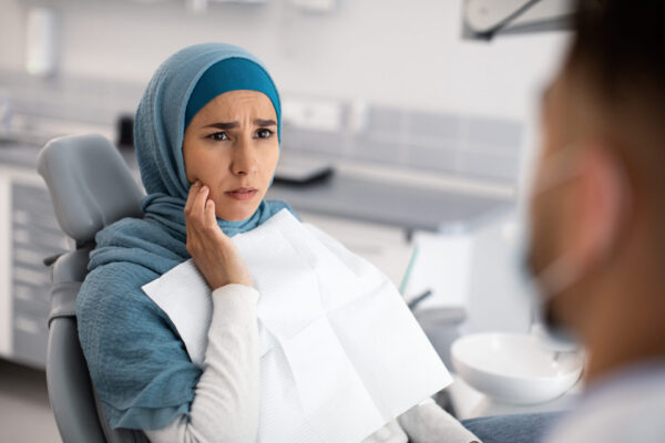 teeth-problems-muslim-female-in-dentist-chair-sho-2022-12-16-09-16-48-utc (1)